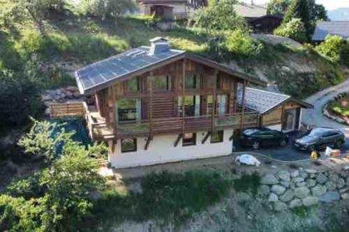 a large wooden house with a solar roof at CHALET UTOPIA in Saint-Gervais-les-Bains