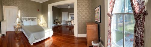 a bedroom with a bed and a hard wood floor at The Wedding Cake House in Providence