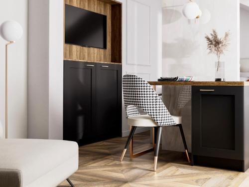 a desk with a chair and a tv on a wall at boutique Villa Dorma in Dubrovnik