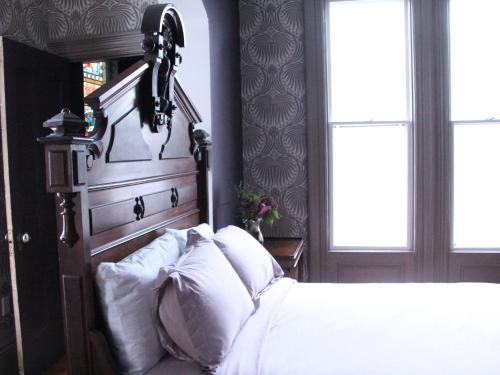 a bedroom with a large bed with white pillows at The Wedding Cake House in Providence