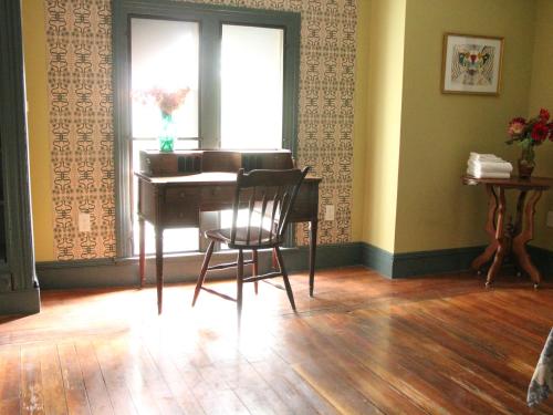 a room with a desk and a window and a chair at The Wedding Cake House in Providence