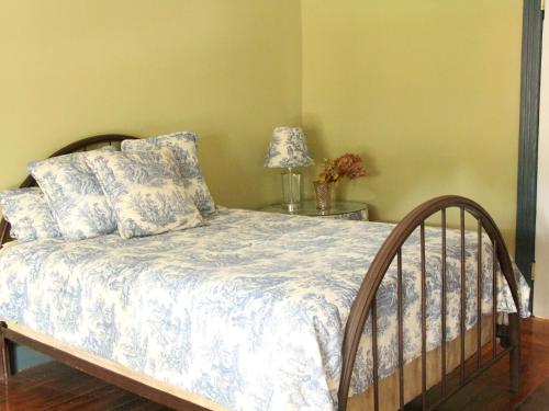 a bedroom with a bed and a table with a lamp at The Wedding Cake House in Providence