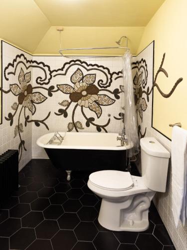a bathroom with a toilet and a bath tub at The Wedding Cake House in Providence