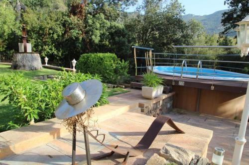 a hat sitting on a table next to a swimming pool at Villa Capllonch in Banyalbufar