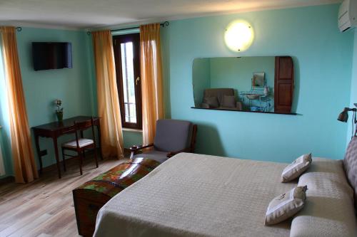 a bedroom with a bed and a mirror and a desk at Le Fiorini in Gargnano