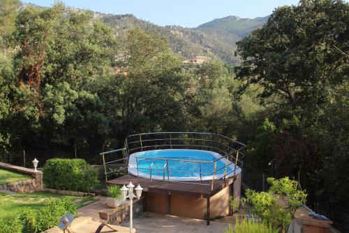 a swimming pool on top of a house with trees at Villa Capllonch in Banyalbufar