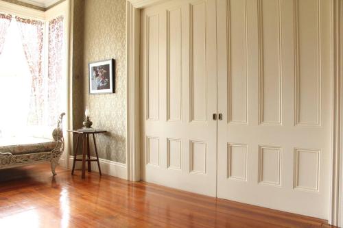 a room with white doors and a wooden floor at The Wedding Cake House in Providence
