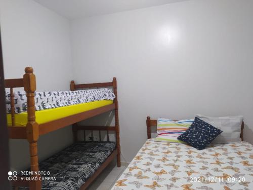 a bedroom with two bunk beds and a pillow at RESIDENCIAL CANTINHO PANTANEIRO in Itapoa