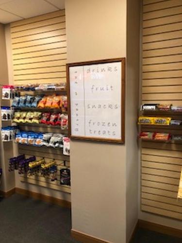 a grocery store aisle with a sign on the wall at The Lodge at Wisp in McHenry
