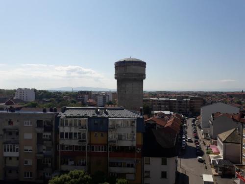 a view of a city with a water tower at Apartman Mihajlovic in Bijeljina