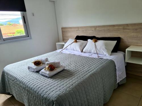 a bedroom with a bed with two towels on it at Departamentos salta in Salta