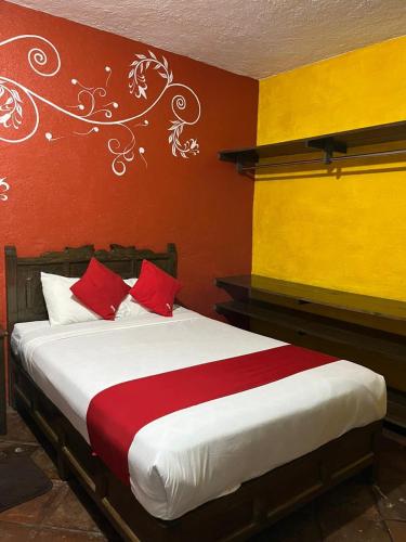 a bedroom with a bed with red and yellow walls at GRUPO MARMIL in San Juan