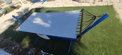 an overhead view of a blue trampoline at Il Trullo al Mare -Trullo by the sea- Pool & Beach in Molfetta