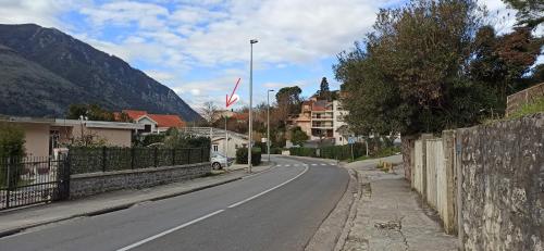 an empty street in a town with a flag at Java Apartments in Dobrota