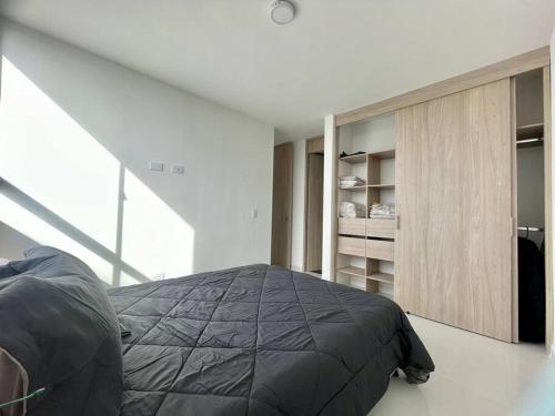 a bedroom with a bed and a book shelf at Rionegro, Apto Moderno Campestre, cerca aeropuerto in Rionegro