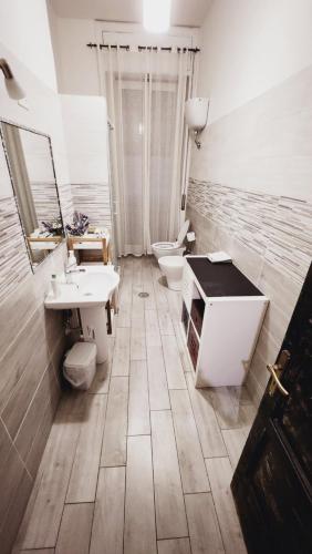 a bathroom with two sinks and two toilets at Home Sweet Home COSENZA in Cosenza