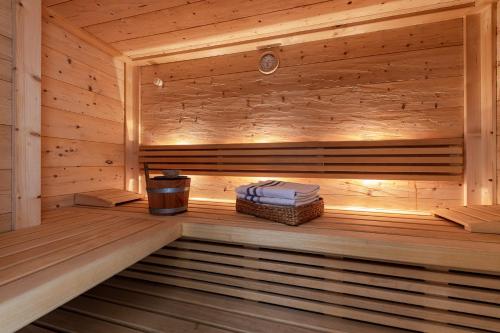 a wooden sauna with a stack of towels in it at Haus Sophie in Longomoso