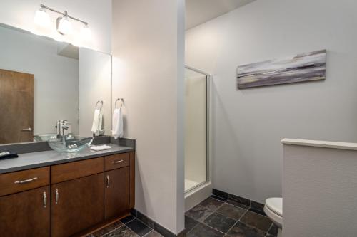 a bathroom with a sink and a mirror at Amazing downtown location for groups! in Little Rock