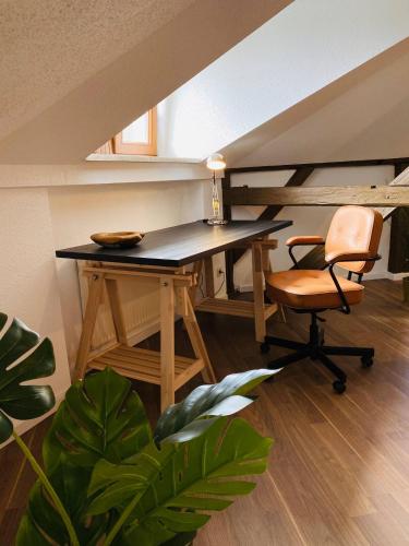 einen Schreibtisch und einen Stuhl in einem Zimmer in der Unterkunft YourFavoriteBed 80m2 Designwohnung im Zentrum 2 in Zwickau