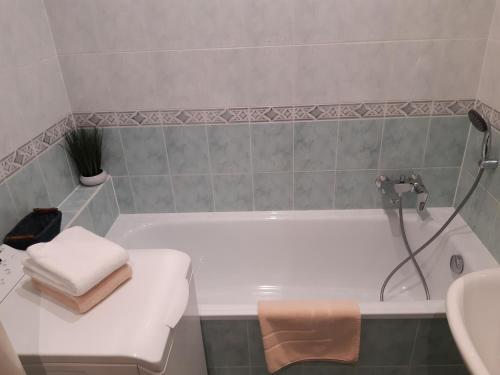 a bathroom with a white tub and a sink at Slnečný 2 izbový byt 10 min. od centra mesta in Banská Bystrica