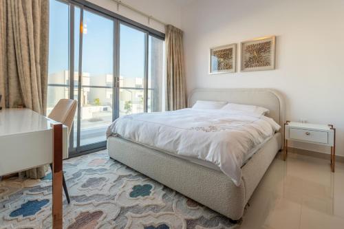 a bedroom with a bed and a desk and a window at Al Dana Sea View Villa in Fujairah