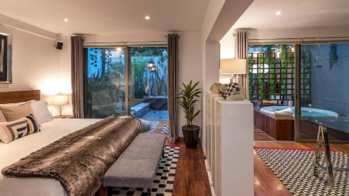 a bedroom with a large bed and a tub at Grand Cinema & Jacuzzi Appartment in Mexico City