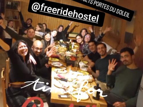 a group of people sitting around a dinner table at Freeride Hostel in Les Crosets
