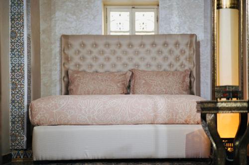 a bedroom with a pink bed with a window at Riad Amelia : Lalla Nora Room in Tétouan