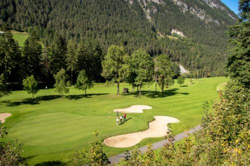 a golf course with a golf cart on a green at Haus Amatschon in Brand