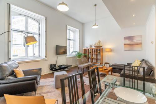 a living room with a glass table and chairs at LV Premier Apartments Chiado- CH in Lisbon