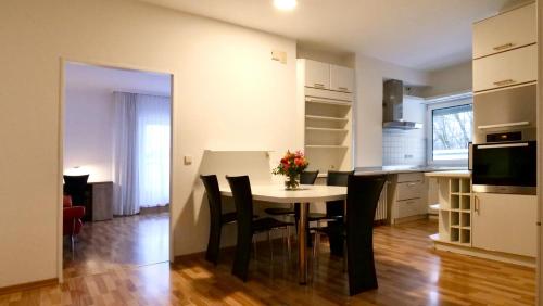 a kitchen and dining room with a table and chairs at Hotel Pegasus in Munich