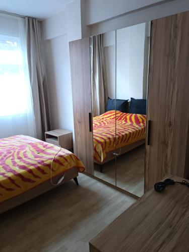 a mirror in a bedroom with a bed at daily rental apartment 5 minutes to the airport in Pazar