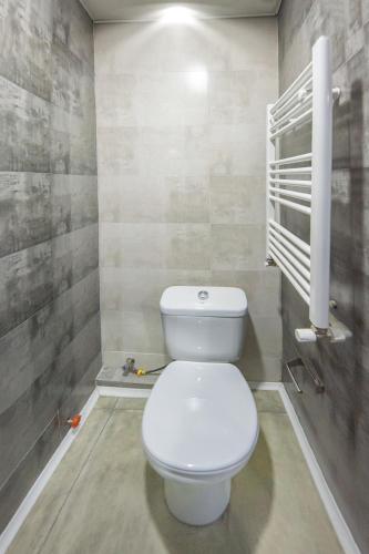 a bathroom with a white toilet in a room at sweet dreams bakuriani in Bakuriani