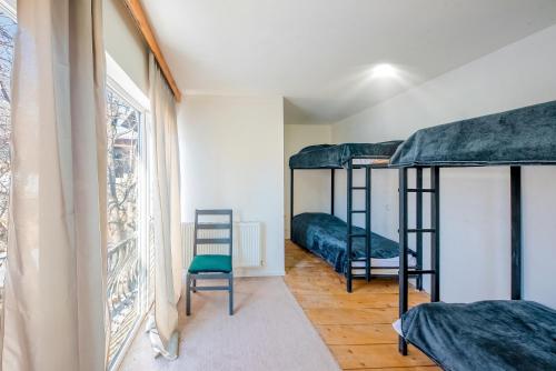 a room with three bunk beds and a chair at sweet dreams bakuriani in Bakuriani