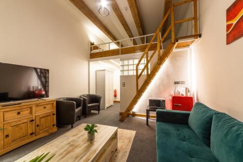 a living room with a couch and a loft at S42 Hotel Prague in Prague