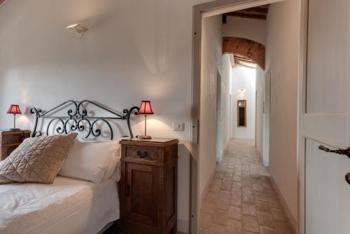 a bedroom with a bed and a lamp on a night stand at Podere Ferranino at Ville Ferrano in San Giovanni dʼAsso