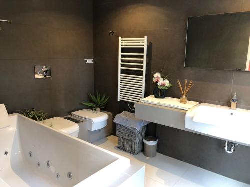une salle de bain avec une baignoire, un lavabo et des toilettes dans l'établissement Appartement montfleury, 2 terrasses, 2 chambres , 2 sdb , pkg privé piscine, 15 min walk to Croisette beach and Palais des festivals, à Cannes