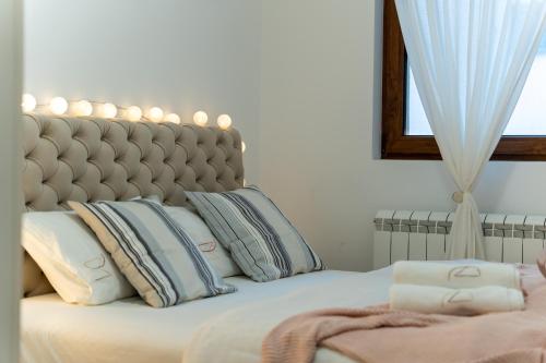 a bedroom with a large bed with pillows on it at Dobro Mesto in Zlatibor