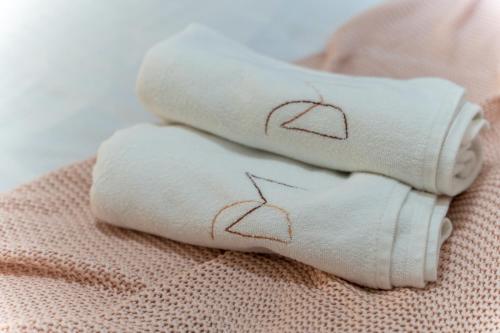 two rolled towels with a heart drawn on them at Dobro Mesto in Zlatibor
