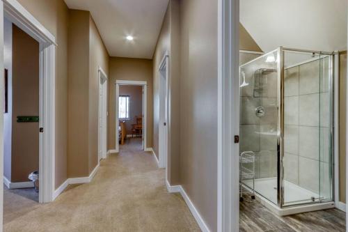 a hallway with a glass shower in a home at Spacious Three Rivers Lodge✦Fenced .5 Acre✦Hot Tub in Bend