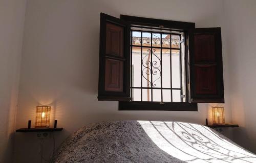 1 dormitorio con cama y ventana en Casa Carmen en Granada