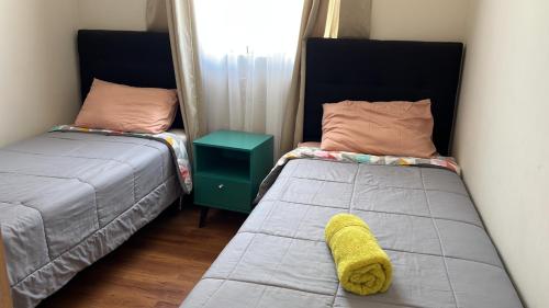 two beds sitting next to each other in a room at Casa Sector Oriente Talca in Talca