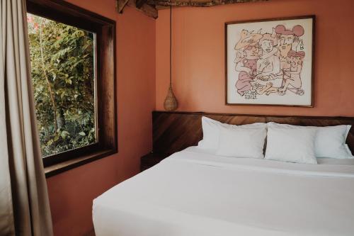 a bedroom with a bed and a window at BOA BOA Bacalar in Bacalar