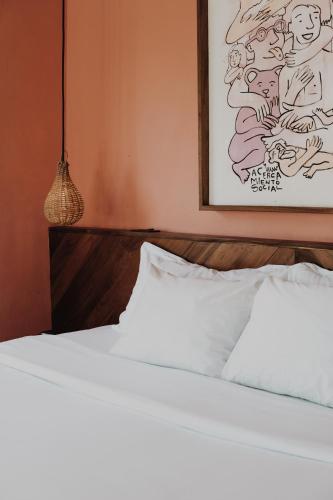 a bedroom with a bed and a painting on the wall at BOA BOA Bacalar in Bacalar