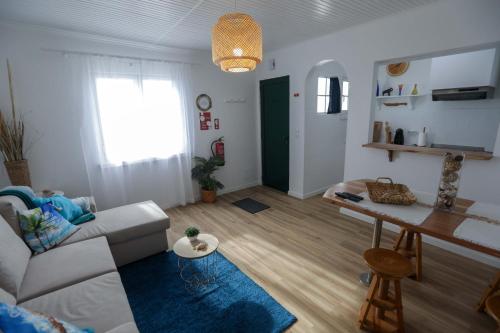 a living room with a couch and a table at Estrela do Atlântico in Ponta Delgada