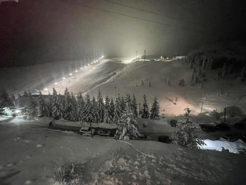 a snow covered ski slope at night with lights at Villa 80 Kodra e Diellit in Tetovo
