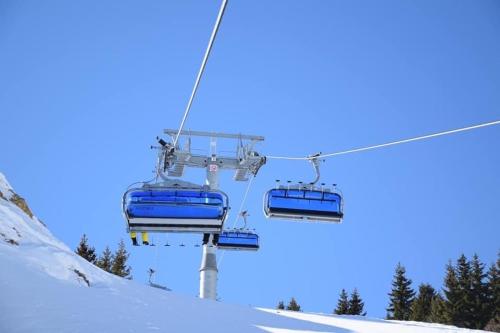 a ski lift with two blue chairs in the snow at Villa 80 Kodra e Diellit in Tetovo