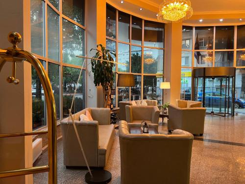 a lobby with couches and chairs in a building at Hotel Aisi in Batumi