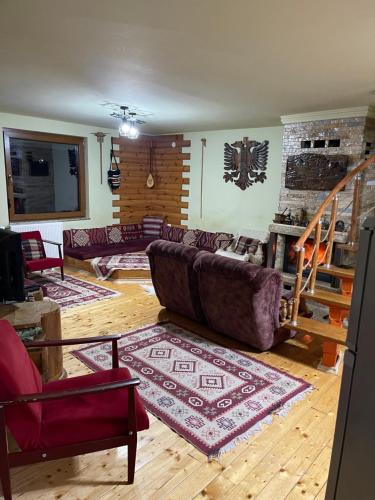 a living room with a couch and a staircase at Villa 80 Kodra e Diellit in Tetovo