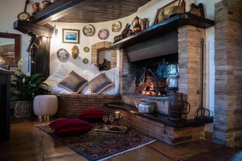 a living room with a brick fireplace with at Borgodoro - Natural Retreat in Magliano Sabina